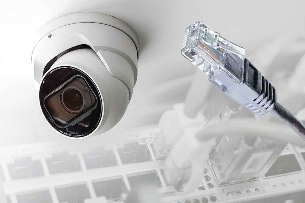IP security camera with a Ethernet wire surrounded by an NVR